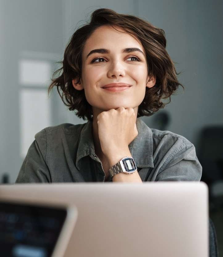 A woman smiling thoughtfully